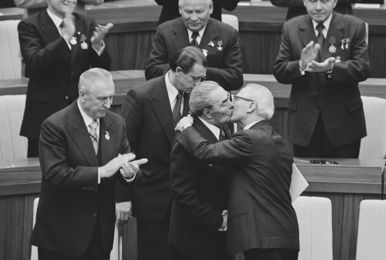 Soviet leader Leonid Brezhnev and East German President Erich Honecker kiss on the occasion of GDR's 30th anniversary. 